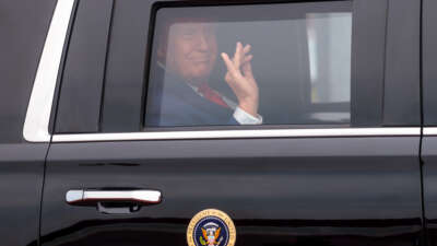 President Donald Trump waves from his limo as he arrives for the 2026 Patriot Games at SPIRE Academy on August 11, 2026, in Geneva, Ohio.