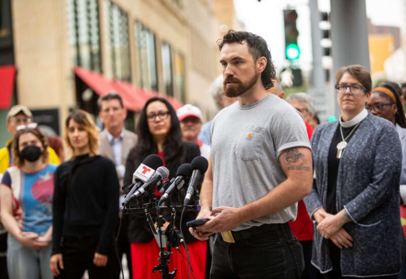 Alec Stewart, one of the 15 people federally indicted for conspiracy to impede or injure federal officers, speaks during a press conference condemning federal surveillance on August 18, 2026.