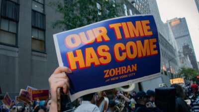 A supporter of Zohran Mamdani holds up a sign ahead of the first mayoral election debate in October 2025.