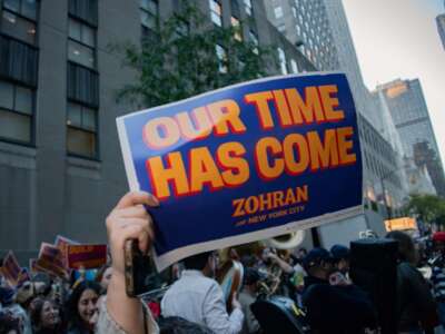 A supporter of Zohran Mamdani holds up a sign ahead of the first mayoral election debate in October 2025.