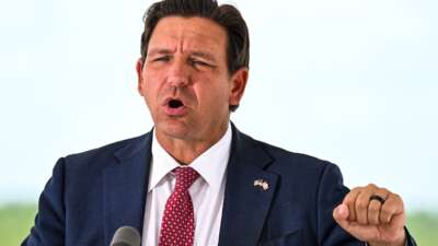 Florida Governor Ron DeSantis speaks during a press conference at the South Florida Detention Facility, nicknamed "Alligator Alcatraz," at the Dade-Collier Training and Transition Airport in Ochopee, Florida, on June 25, 2026.