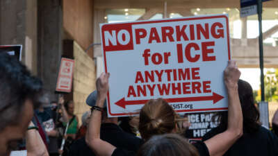 A protester holds a sign at a protest outside the Icon parking garage in Manhattan on September 14, 2026.