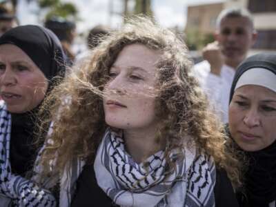 Palestinian activist Ahed Tamimi (center) arrives for a press conference with her mother Nariman (right) after her release from an Israeli prison where she served a sentence of eight months for slapping an Israeli soldier in her hometown of Nabi Saleh, West Bank, on July 29, 2018.