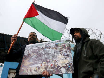 Palestinian refugees gather outside the offices of the UN agency for Palestinian refugees, UNRWA, in Beirut, Lebanon, on January 30, 2024, to protest against some countries' decision to stop funding the organization.