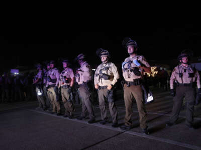 Illinois State Police stand guard while monitoring protesters gathering near an Immigration and Customs Enforcement facility in Broadview, Illinois, on October 4, 2025.