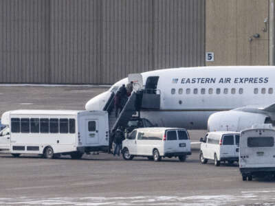 Migrants board an Eastern Air Express flight at Minneapolis-St. Paul International Airport on January 11, 2026, in Minneapolis, Minnesota. The Department of Homeland Security has been running deportation flights out of the private charter Signature Aviation.