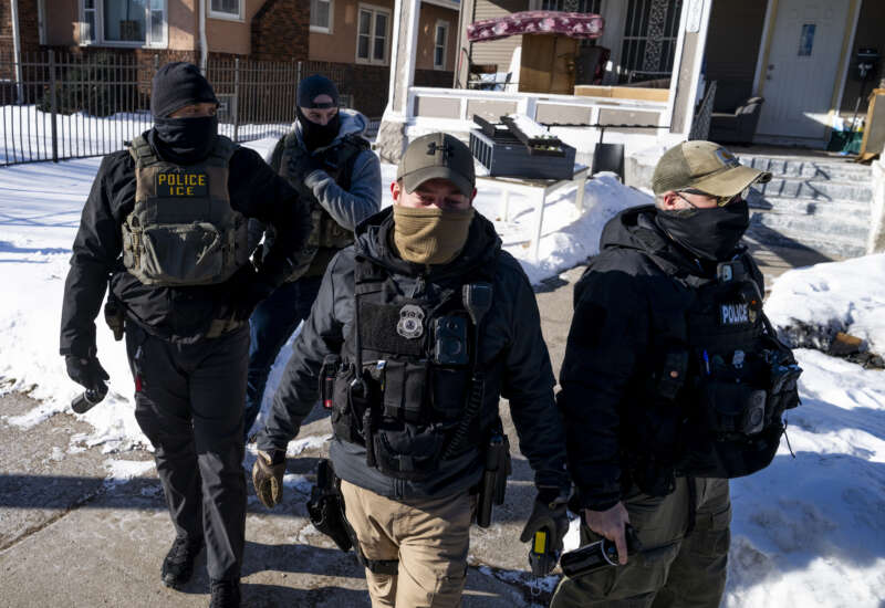 ICE agents leave a residence after knocking on the door on January 28, 2026, in Minneapolis, Minnesota.