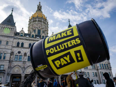 Environmental advocates gather at the capitol building in Hartford, Connecticut, on January 28, 2026, to demand fossil fuel companies pay for climate disasters through a climate superfund.