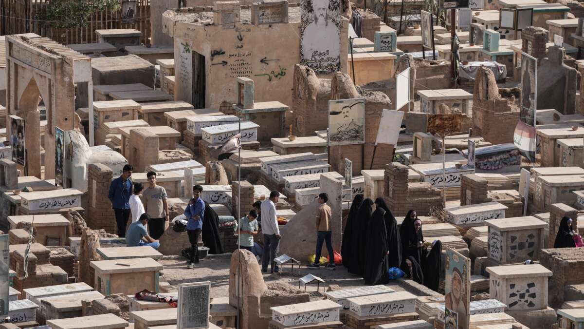 Iraqis visit the graves of their loved ones on the first day of Eid al-Adha, the Feast of Sacrifice, in Iraq's holy city of Najaf on May 27, 2026.
