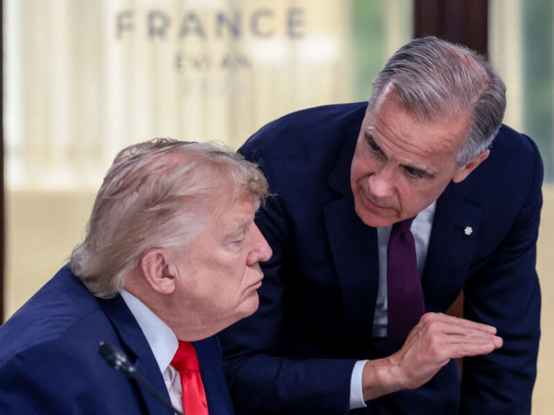 U.S. President Donald Trump speaks with Canada's Prime Minister Mark Carney during a work lunch as part of the G7 summit, in Evian, eastern France, on June 16, 2026.