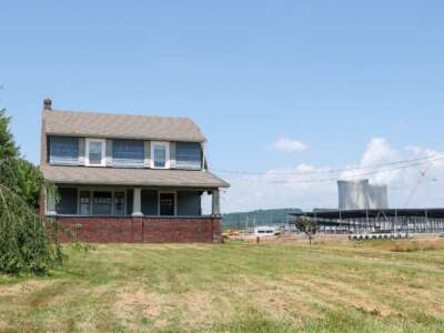 A vacant house is seen next to an Amazon Web Services data center construction project adjacent to Talen Energy's Susquehanna Steam Electric Station nuclear power plant.