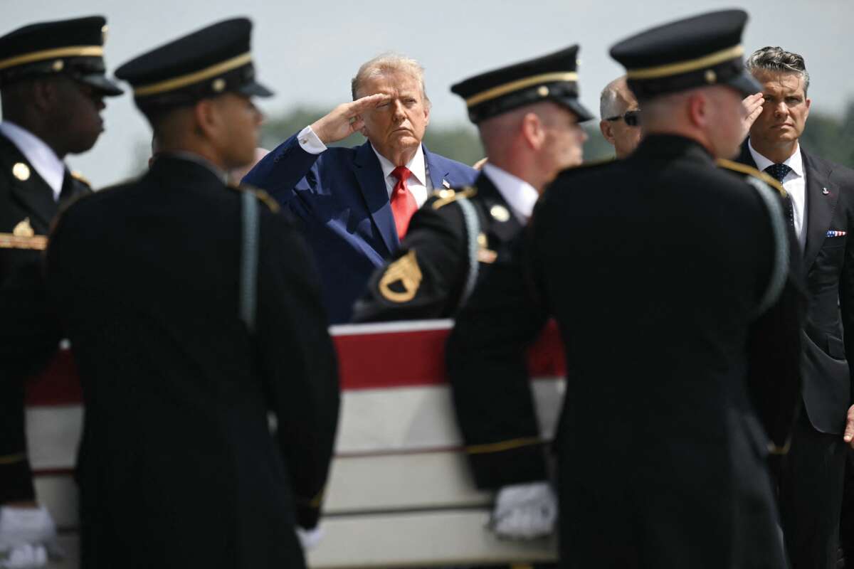 President Donald Trump and Secretary of Defense Pete Hegseth salute as a U.S. Army carry team carries the flag-draped transfer case containing the remains of Sgt. Angel S. Rampersad, 28, of Ozone Park, New York, during a dignified transfer solemn event for U.S. service members killed during operations in the Middle East, at Dover Air Force Base in Dover, Delaware, on July 22, 2026.