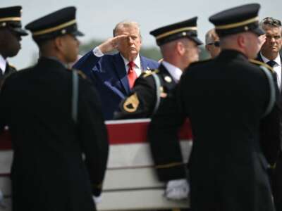 President Donald Trump and Secretary of Defense Pete Hegseth salute as a U.S. Army carry team carries the flag-draped transfer case containing the remains of Sgt. Angel S. Rampersad, 28, of Ozone Park, New York, during a dignified transfer solemn event for U.S. service members killed during operations in the Middle East, at Dover Air Force Base in Dover, Delaware, on July 22, 2026.