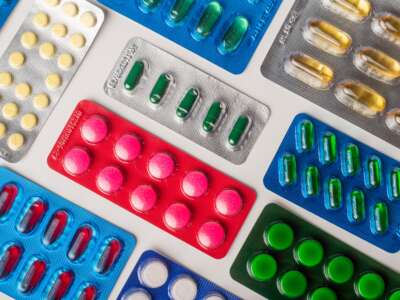 Multiple packs of medicine are laid out on a flat surface.