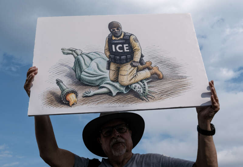 A demonstrator holds an anti-ICE sign while attending the "March on Washington: Defend the Vote" rally at the Lincoln Memorial in Washington, D.C., on August 28, 2026.