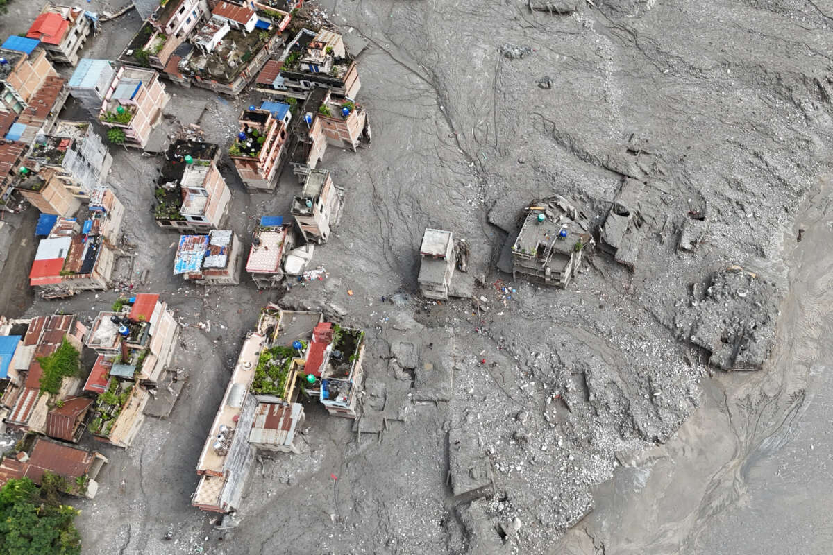 An aerial view shows houses damaged and deluged in sludge in the aftermath of climate-driven flash floods at Trishuli Center in Nepal's Nuwakot district, on September 1, 2026.
