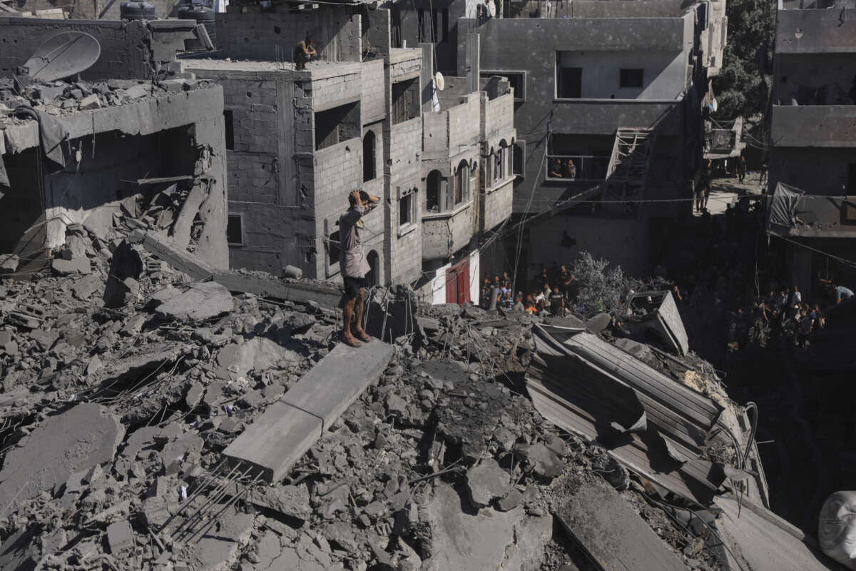 Residents move through rubble between damaged residential buildings after an Israeli airstrike in the Abu Dalal area of Nuseirat refugee camp, central Gaza Strip, on September 9, 2026.