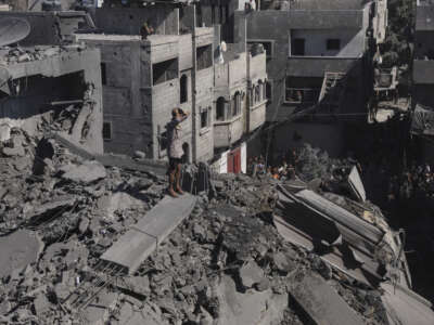Residents move through rubble between damaged residential buildings after an Israeli airstrike in the Abu Dalal area of Nuseirat refugee camp, central Gaza Strip, on September 9, 2026.