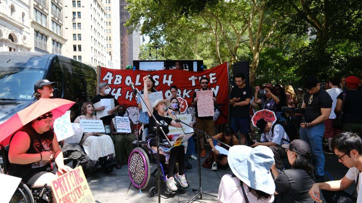 Raine Reilly speaks at a protest outside City Hall to end 24-hour shifts for home care workers in New York City.