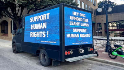 A mobile billboard is circles the DNC meeting in Austin, Texas, urging the Resolutions Committee to vote to support a commitment to human rights and to upholding the Leahy Laws, on August 13, 2026.