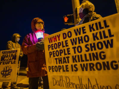 Bloomington anti-death-penalty activist Glenda Breeden holds a lamp while protesting against the execution of Lisa Montgomery, and two others who are scheduled at Terre Haute Federal Prison, in Bloomington, Indiana, on January 12, 2021. Jeremy Hogan / SOPA Images / LightRocket via Getty Images
