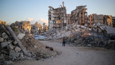 A man walks past buildings destroyed by Israeli airstrikes on October 7, 2026, in Gaza City, Gaza.