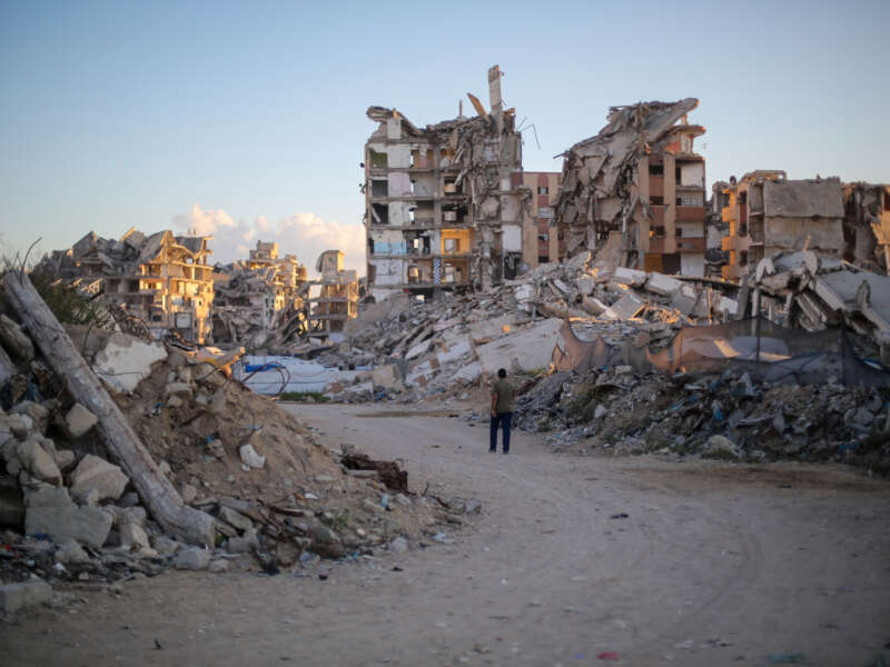 A man walks past buildings destroyed by Israeli airstrikes on October 7, 2026, in Gaza City, Gaza.