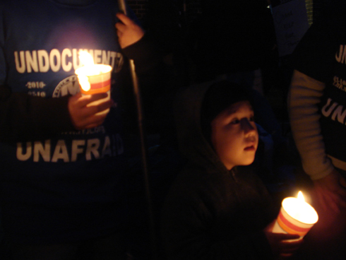 Young children attend the candlelight vigil outside Broadview Detention Center.