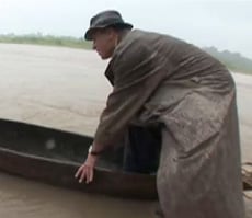 Greg Palast getting in canoe.