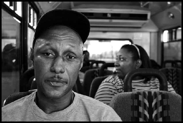 Lorenzo Reed, a worker at the Smithfield pork plant in Tar Heel, North Carolina, in the parking lot in Dillon, South Carolina, where workers wait for vans to take them to their jobs. It takes hours to get there.