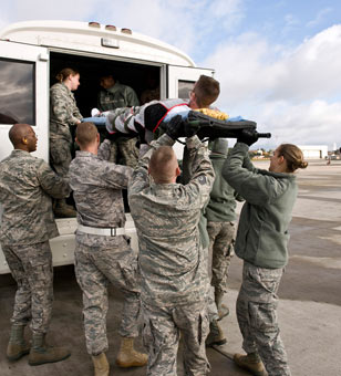 Medical personnel from Ramstein AB, Germany transfer wounded service members from a KC-135 aircraft to buses that will move them to other medical facilities in the area including Landstuhl Regional Medical Center, October 20, 2010. (Photo: <a href=