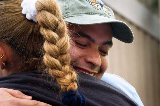 Raul Alcaraz Ochoa hugs René Meza's sister-in-law Lizbeth Hernandez, who spoke about what happened to her brother-and-law and his family. (Photo: Murphy Joseph Woodhouse)