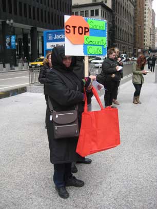 A protestor in Chicago’s Daley Plaza says no to Social Security cuts while fellow dissenters deliver petitions to Senators Mark Kirk and Dick Durbin on April, 2013. (Photo: Claire Glass)