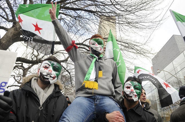 Young unidentified Syrians chanting slogans during a protest rally organized to raise awareness and commemorate two years of Syrian revolution on March 16, 2013 in Toronto, Canada. (Photo: <a href=