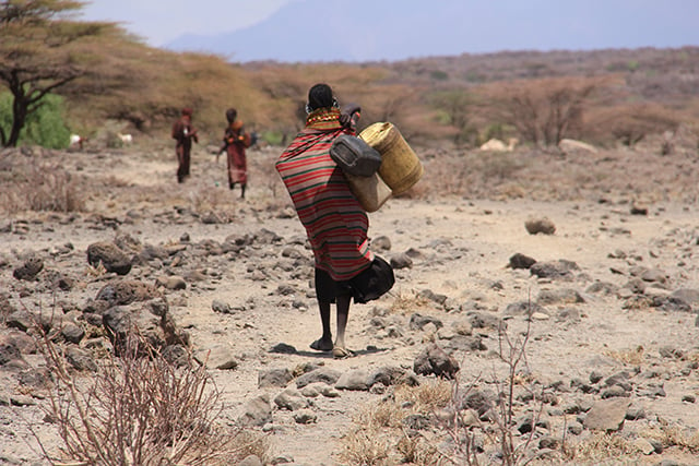 A woman collects water. (Photo: Chris Williams and Maria Davis)