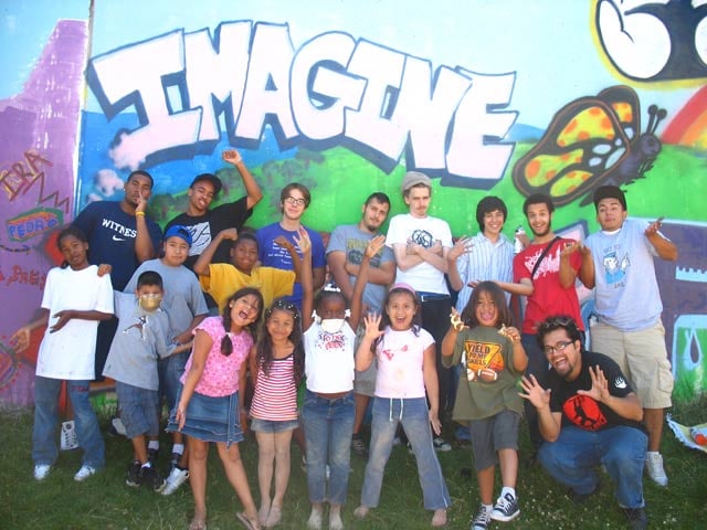 Rios, bottom left, taking part in the creation of a community mural in 2008. (Courtesy of Christine Malesky)