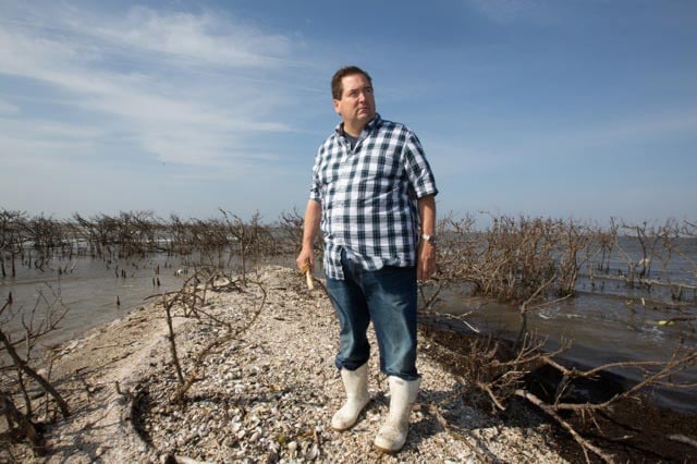 Billy Nungesser on Cat Island holding a pelican bone three years after the BP oil spill, April 18, 2013. (Photo: ©2015 Julie Dermansky)