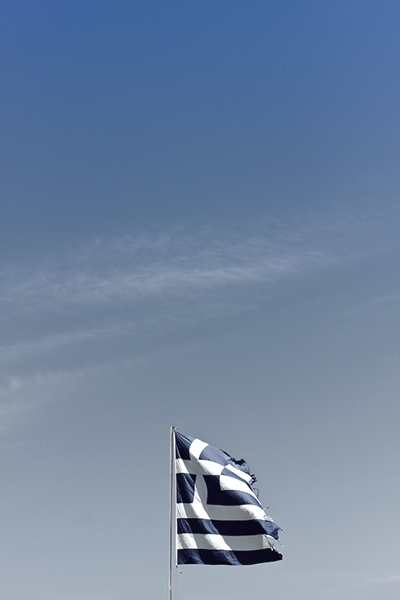 It is astonishing that the European elites have convinced themselves that adhering to the procedures used to implement clearly unsuccessful austerity programs are so important as to justify creating a failed state. (Photo: Torn Greek Flag via Shutterstock; Edited: LW / TO)
