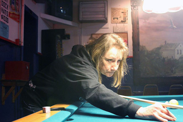 The bartender of the Dry Dock plays pool with other regulars. (Photo credit: Eduardo García)