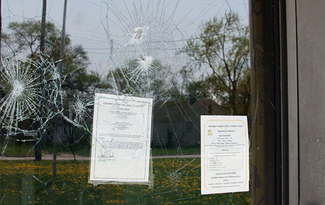 The smashed glass of the front entrance of Martin Luther King Jr. Elementary School, which closed after students fled the charter school district. (Photo credit: Eduardo García) 