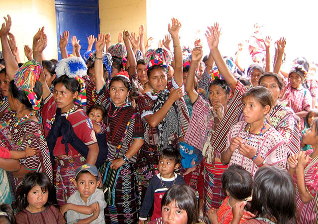 Mayan women raise their hands to vote against mining in a 2007 community consultation in the municipality of Colotenango, in the Huehuetenango department. (Photo: Sandra Cuffe)