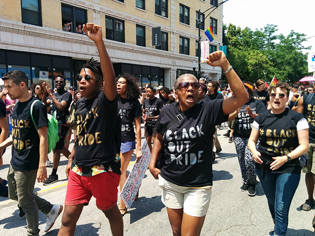 Shortly before reaching the site of the action, participants put on shirts bearing the hashtag of the event. (Photo: Kelly Hayes)