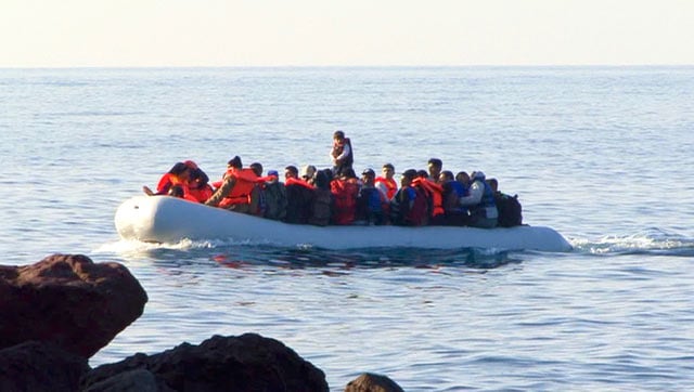 An inflatable boat emerged through the haze, lit up by the bright orange of 50 to 60 life-jacketed passengers, writes James Fennell. (Photo: Peter Bach)