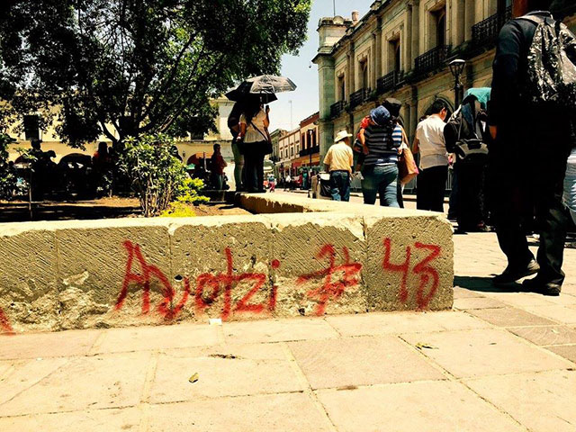 Graffiti remembering the 43 disappeared in Oaxaca City's central square. (Photo: Simon Davis-Cohen)