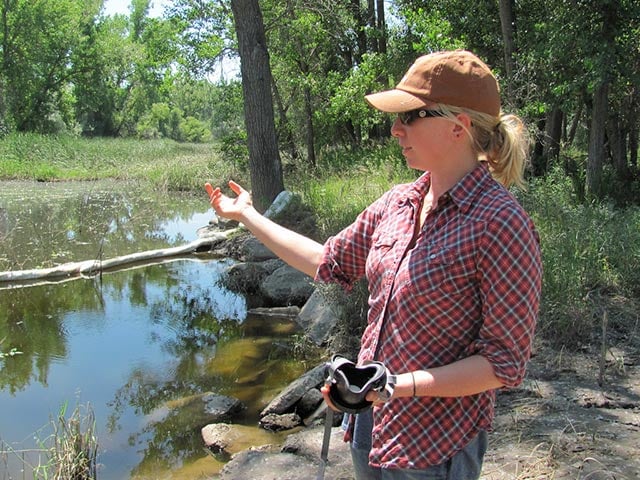 Alexis Bonogofsky shows where the oil is on the the Bonogofsky farm during the 2011 Exxon oil spill on the Yellowstone River. (Photo: Kate Sheppard)