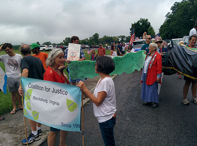 Campaigners belonging to the Coalition for Justice, Blacksburg, gather at the town's July 4 parade to protest the open burning of munitions at the nearby Radford Army Ammunitions Plant (Photo: Coalition for Justice, Blacksburg) 