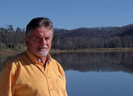 Retired laborer Johnny Church, who shoveled coal ash at the TVA spill site, stands on a dock in the former disaster zone, which is now a public park. (Photo: Kristen Lombardi / Center for Public Integrity)