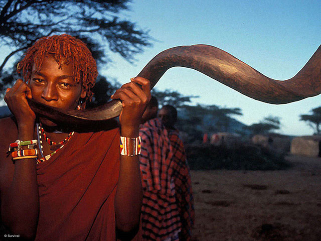 A Maasai Moran blows a kudu horn as a symbol of his coming of age in Kajiado, Kenya. The BBC's new documentary 