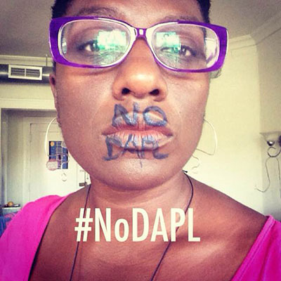 Atena Danner, a Chicago organizer with the Lifted Voices direct action collective shows support for #NoDAPL on social media. (Photo: Courtesy of Atena Danner)