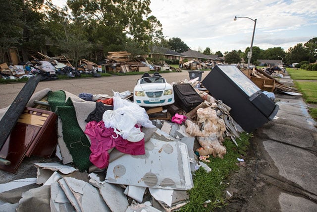 Many residents are still waiting for the piles of debris in front of their homes to be removed after the August flood, as seen along this street in the Monticello neighborhood of Baton Rouge, Louisiana, on September 15. (Photo: Julie Dermansky)
